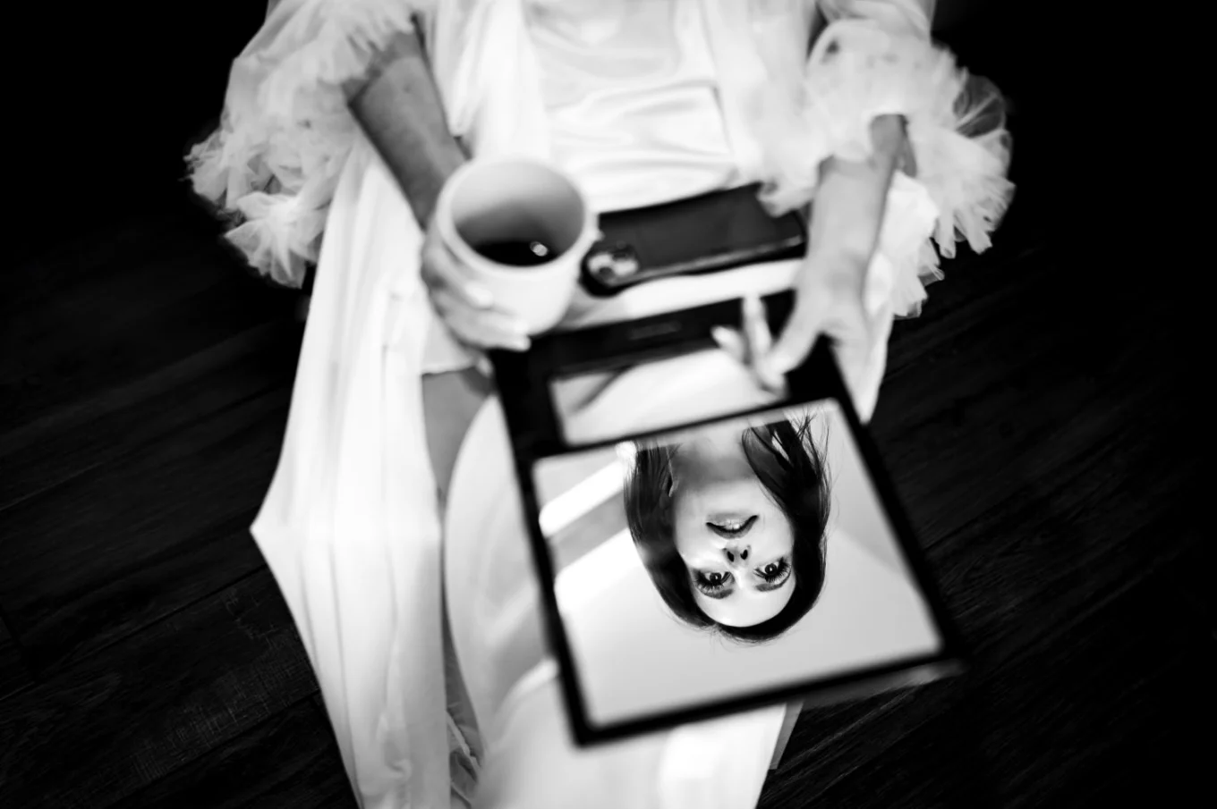 Camore wedding photography of the bride sitting on the chair with her face reflected in the small mirror
