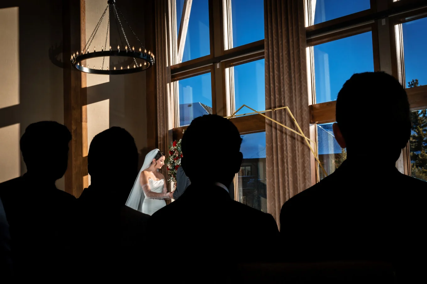 Canmore Wedding Photography of the bride and silhouetted guests looking at her.