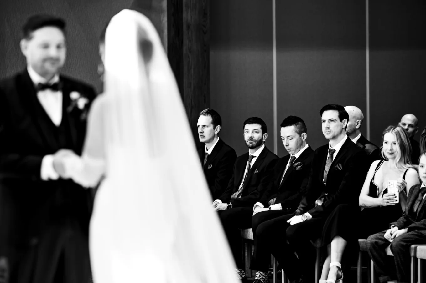 Groomsmen looking at the newlyweds on the wedding ceremony in Canmore.