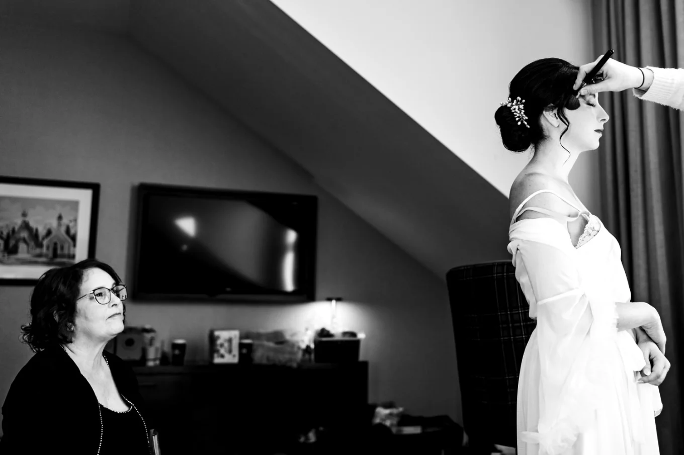 Mather looks at the bride wearing a wedding dress in Canmore