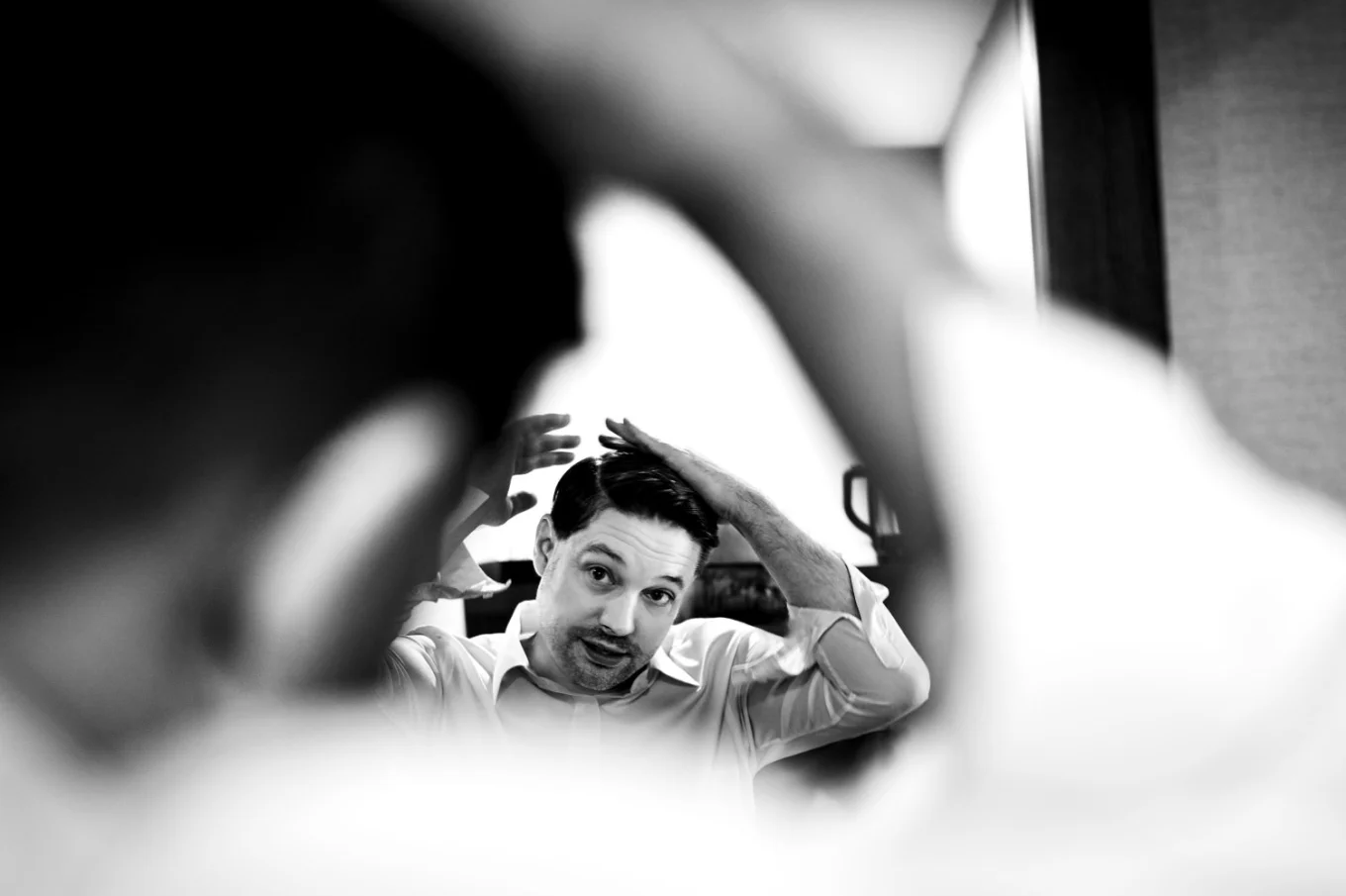 Groom brushes his hair before wedding in canmore