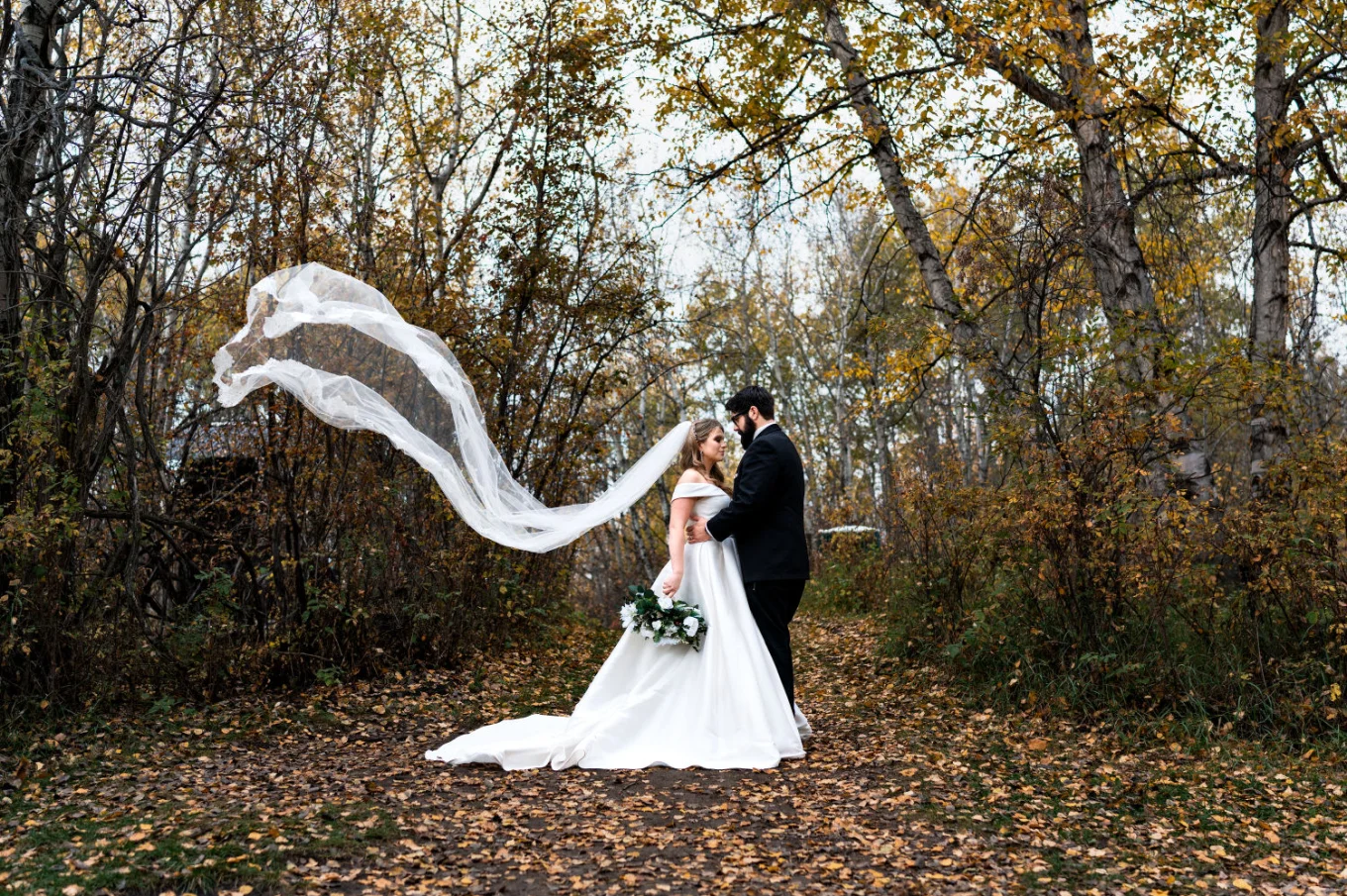 Incredible portrait of the bride and groom with flying veil in the park in Edmonton.