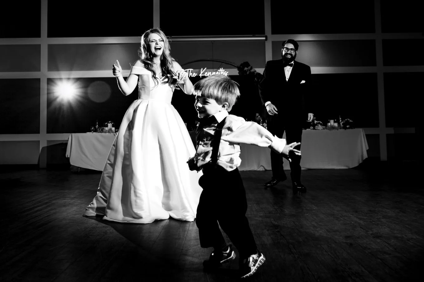 Bride, groom and their little son dance at the dance-floor in Edmonton