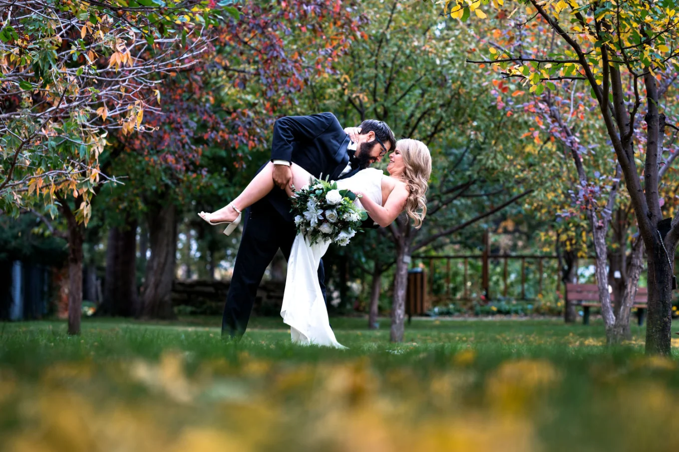 Edmonton Wedding Portrait of the groom kissing the bride in the park.