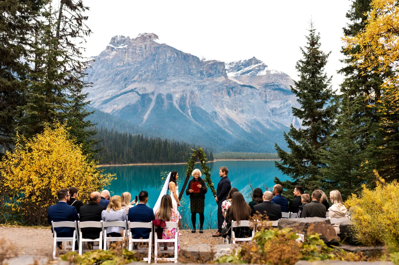 Beautiful fall wedding ceremony against the mountains and lake in Banff National Park.