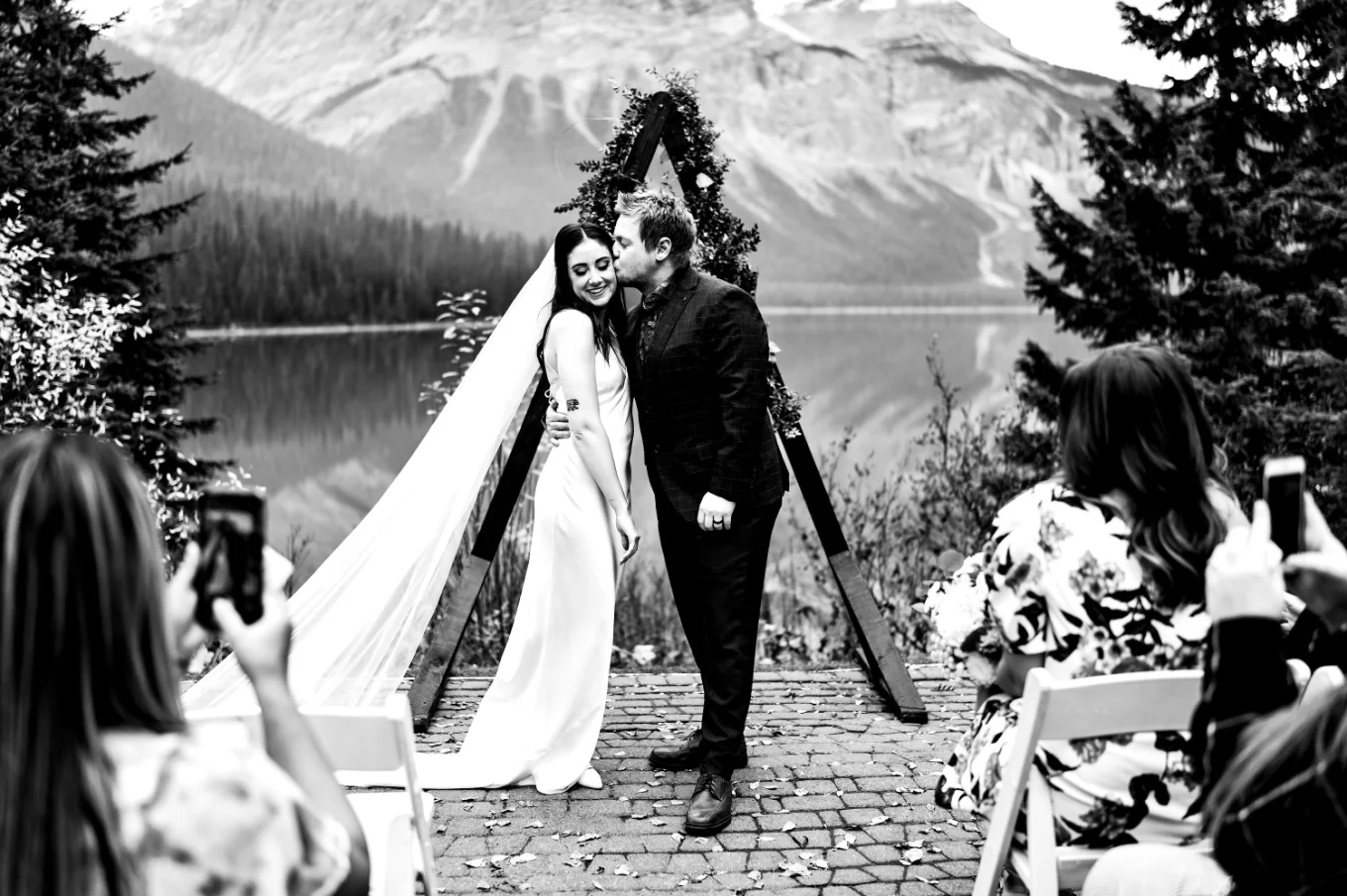 The groom kisses his wife on the cheek after Banff Elopement Ceremony