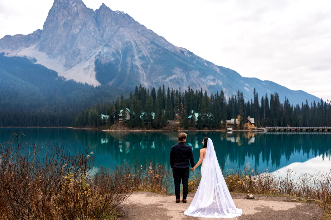Banff Wedding Photography at Emerald Lake of the bride and groom looking at the mountains.