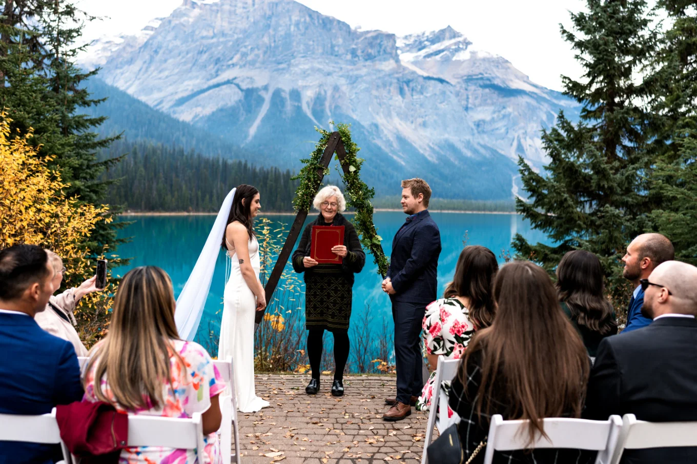 Stunning elopement ceremony at Emerald Lake against Rocky Mountains