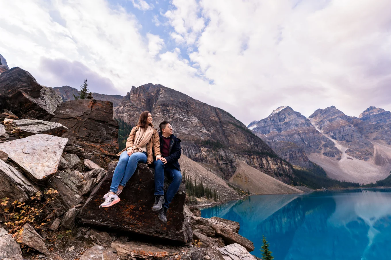 young couple in love cooking at the sky in the Canadian rockies