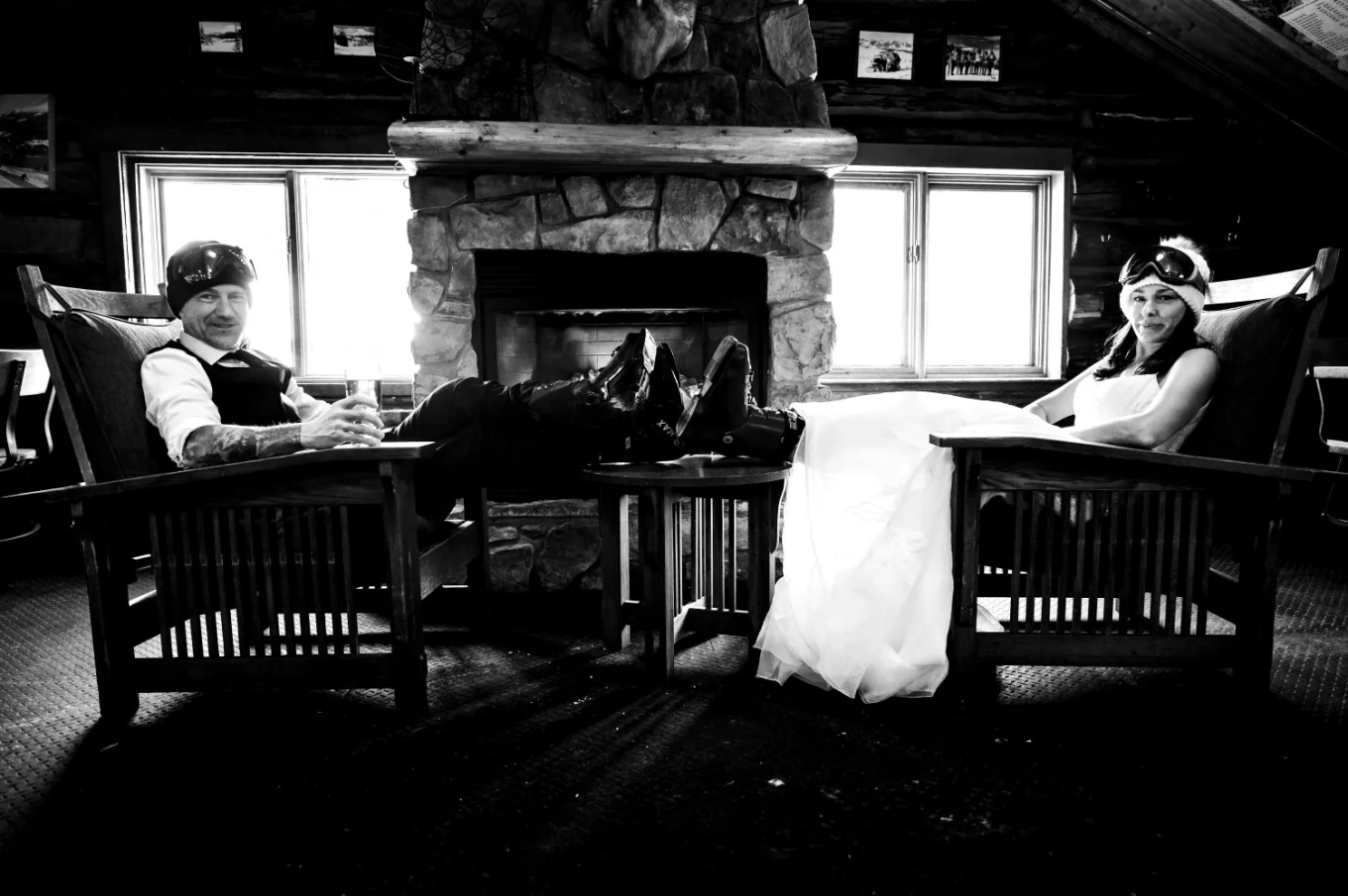 Bride and groom take break after long skiing day with their legs on the coffee table.