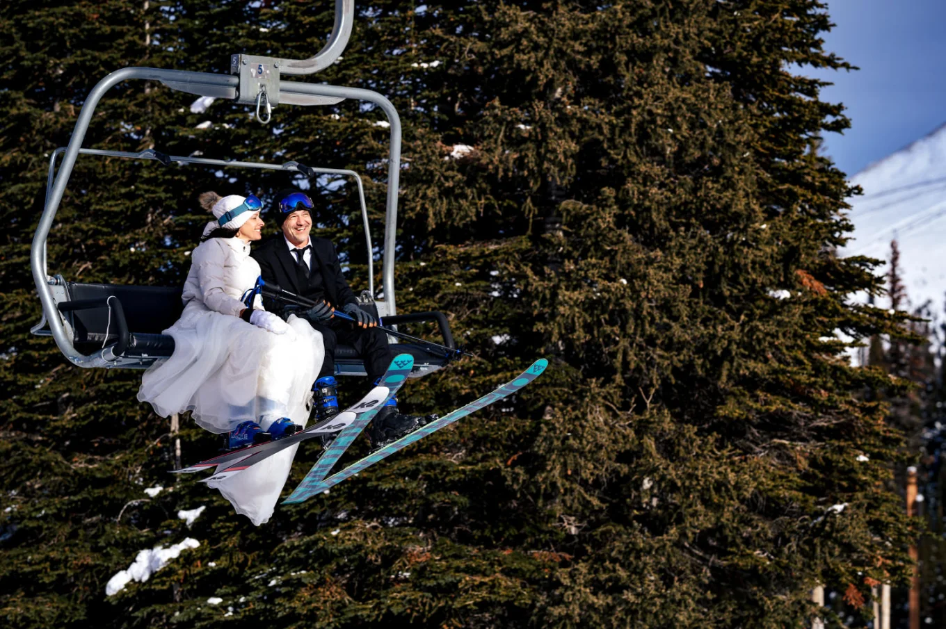 Newlyweds at the ski lift at Sunshine Village ski resort.