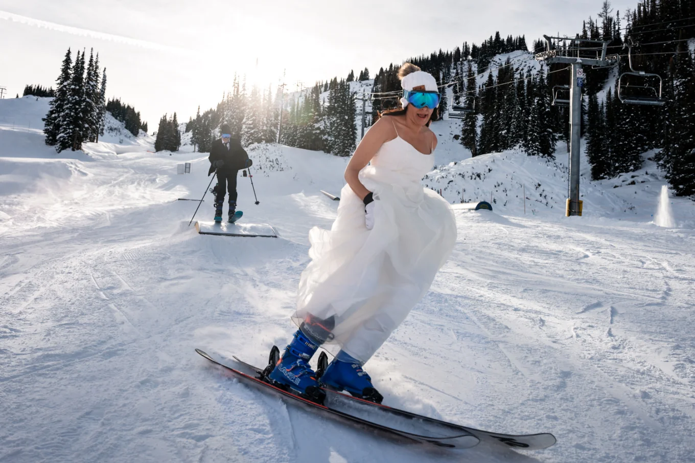 Bride wearing wedding dress and skiing in Banff.