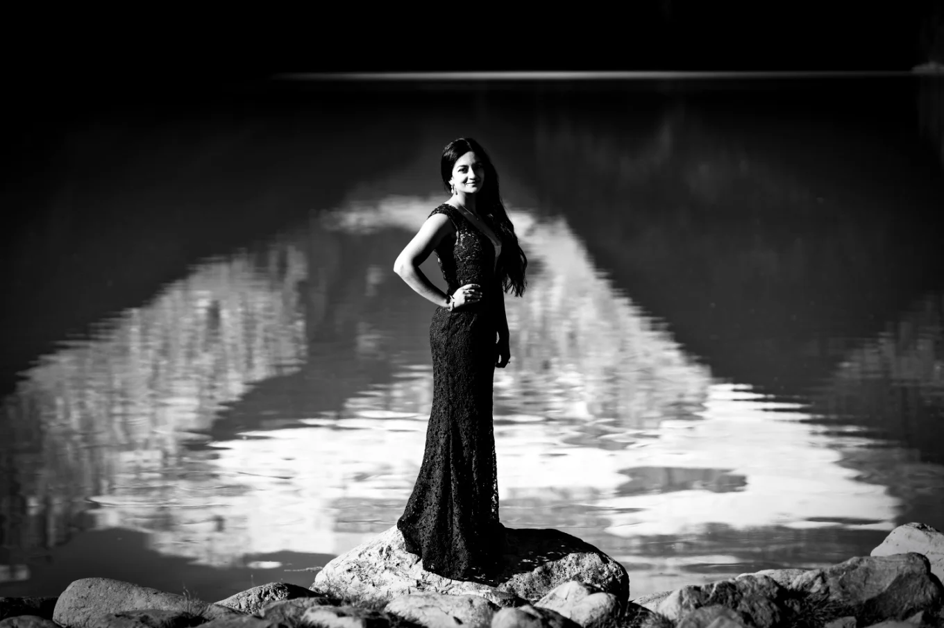 handsome lady standing at Lake Loise shore in a long dress