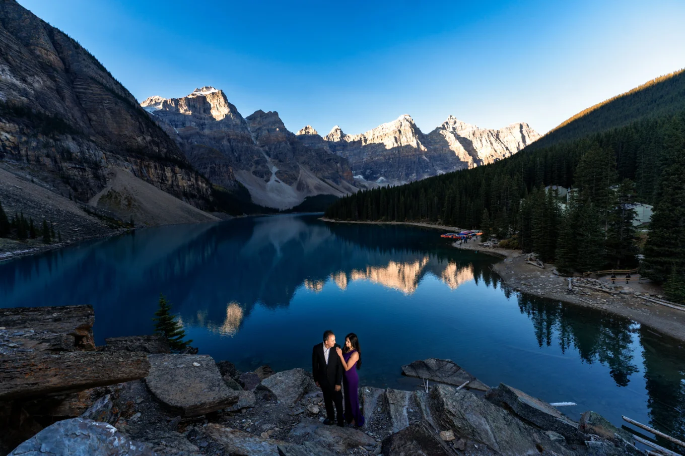 Anniversary Photo Session at Moraine Lake of the couple in love standing on the huge rocks.