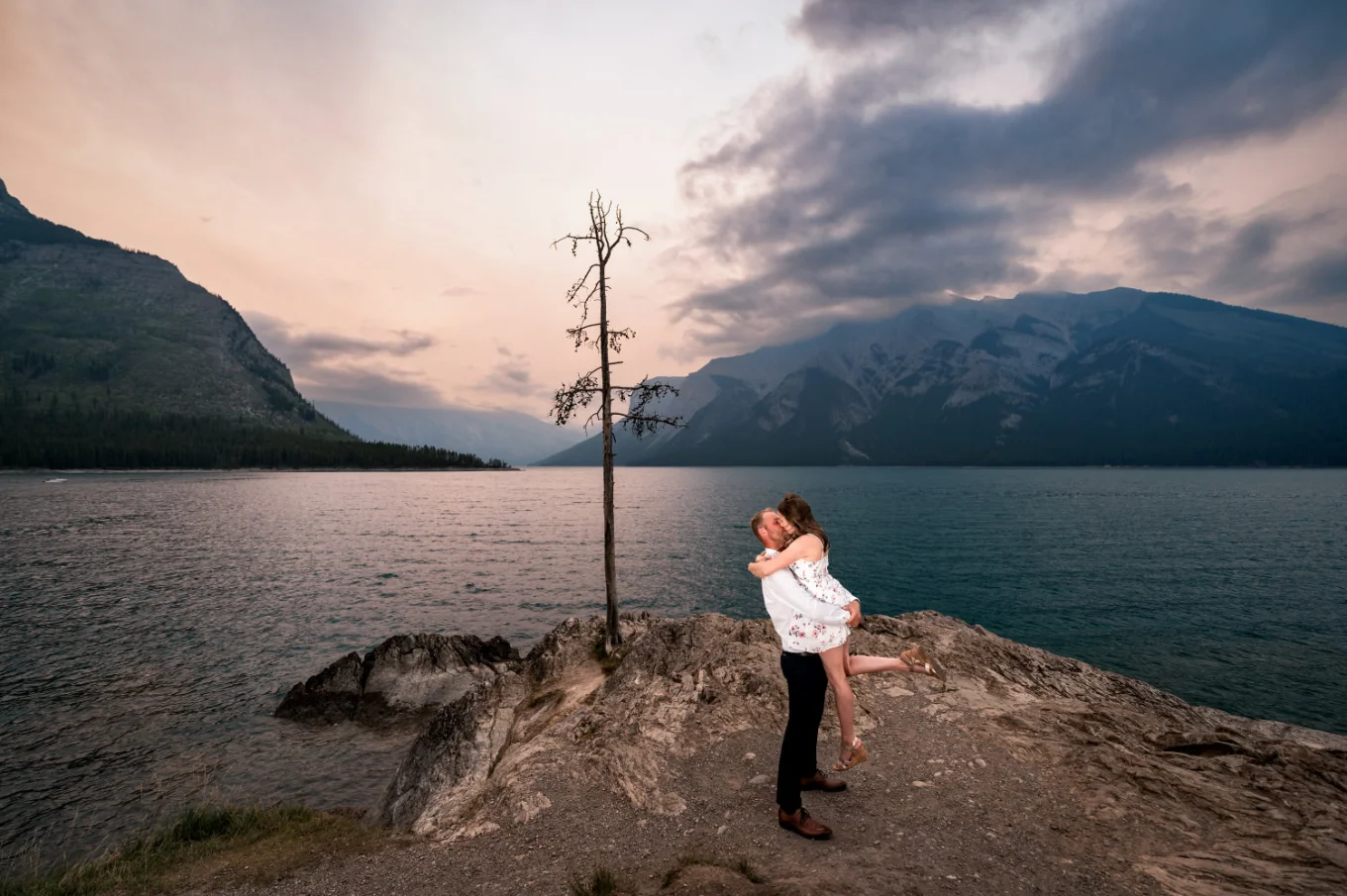 Romantic Banff Proposal Photography of the happy couple during sunrise at Minnewanka Lake