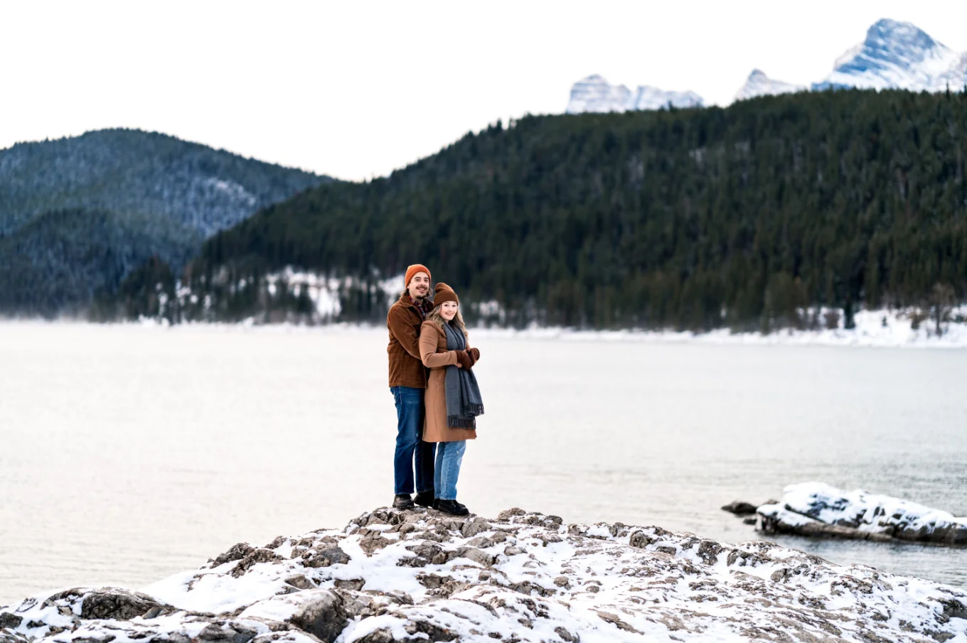 Man hugs his fiancee from behind on their Banff Engagement Session.