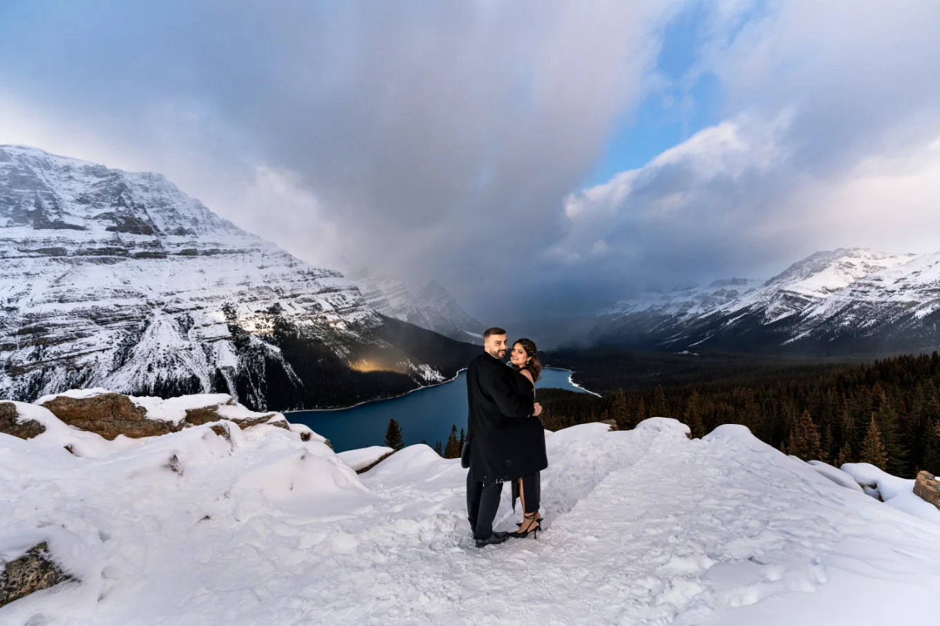 Banff Engagement Photography of the couple in a hug against rocky mountains.