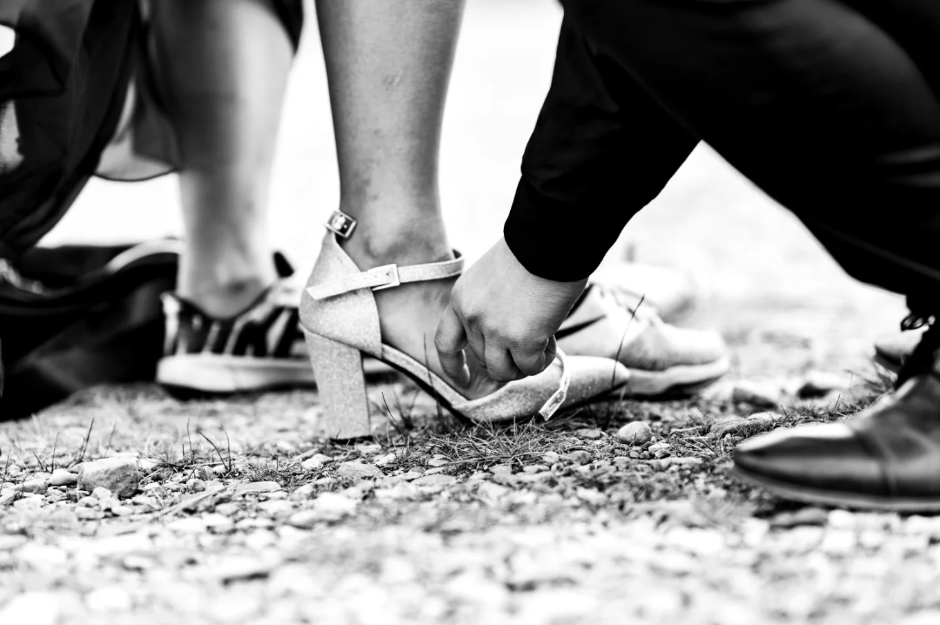 Man helps his fiancee whith the shoe.