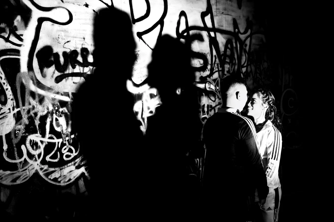 Creative engagement photography shadow of the couple facing each other.