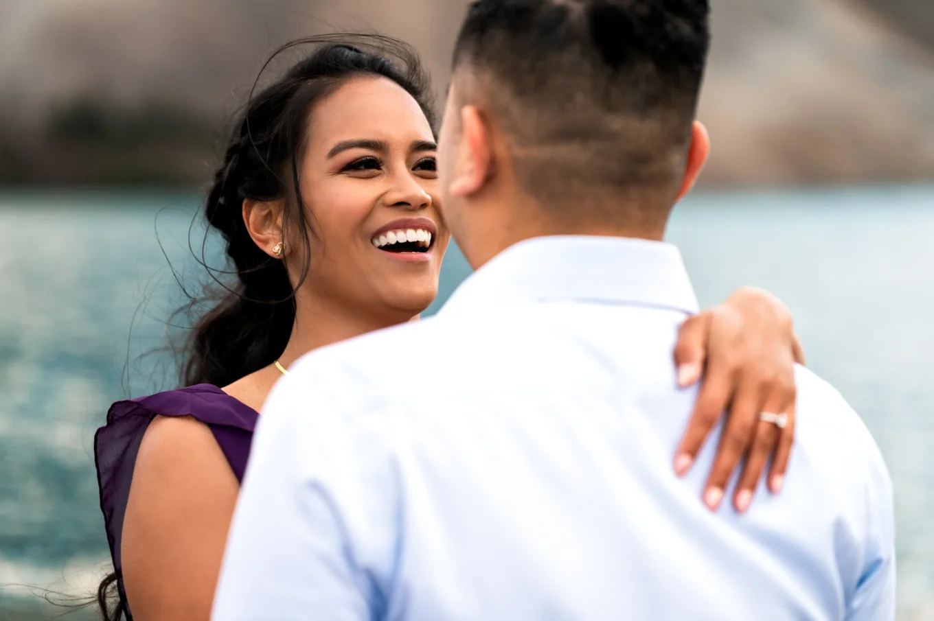 Youn lady looks with love at her fiancee and smiles.