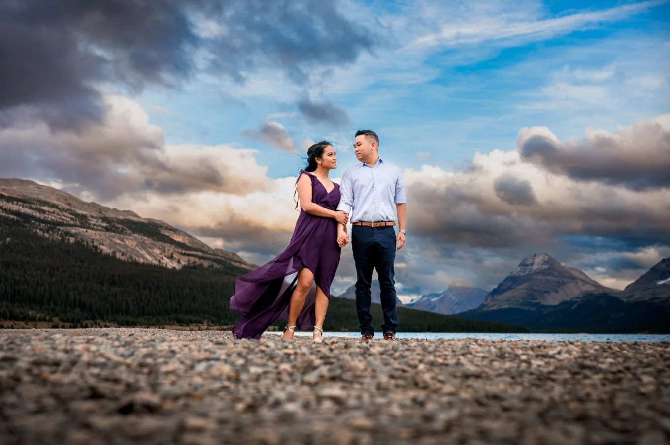 Romantic Engagement of the coupe looking at each other and holding hands in Banff National Park during sunset.