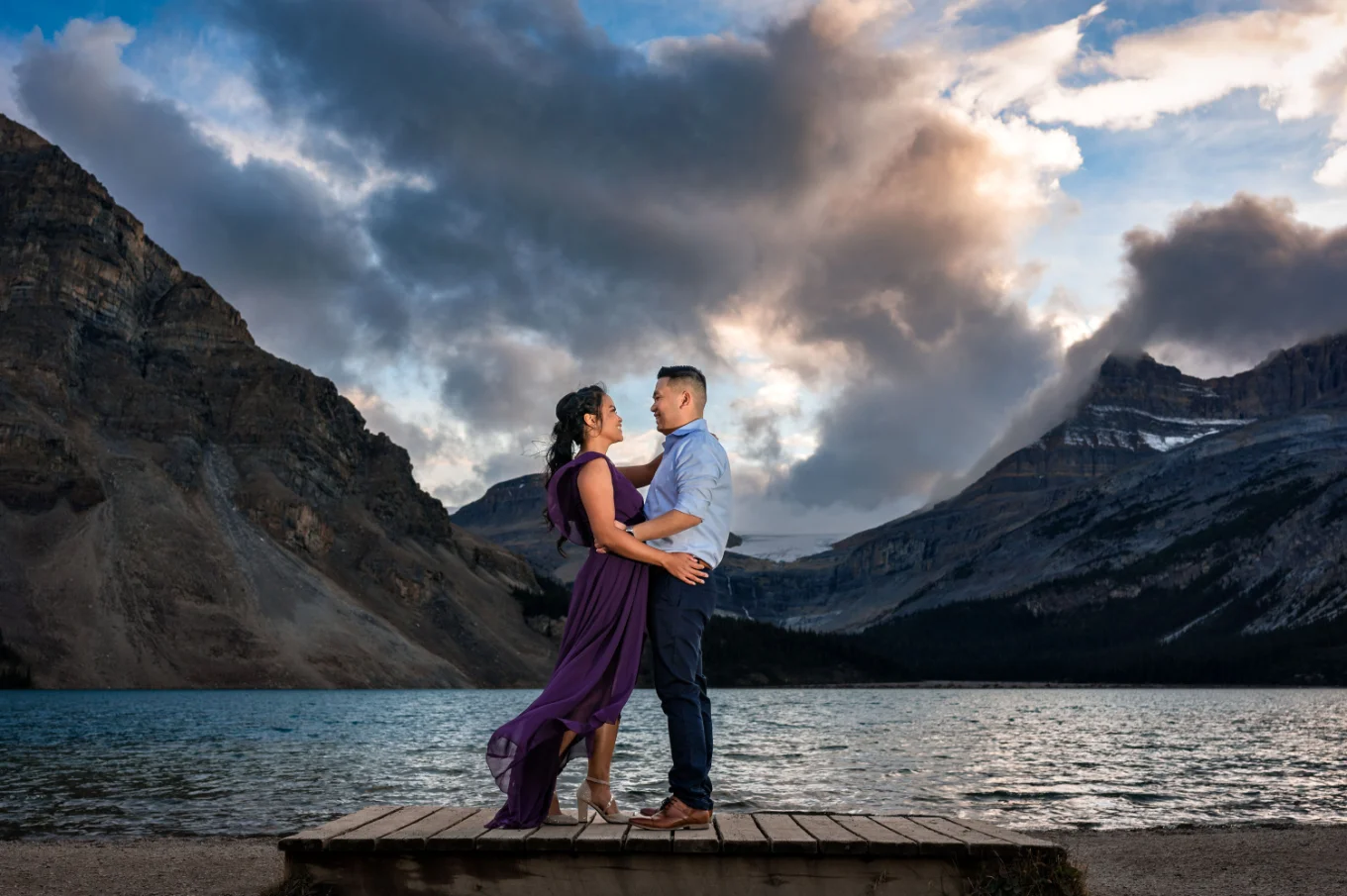 Engaged couple in a hug during stunning sunset in Banff.