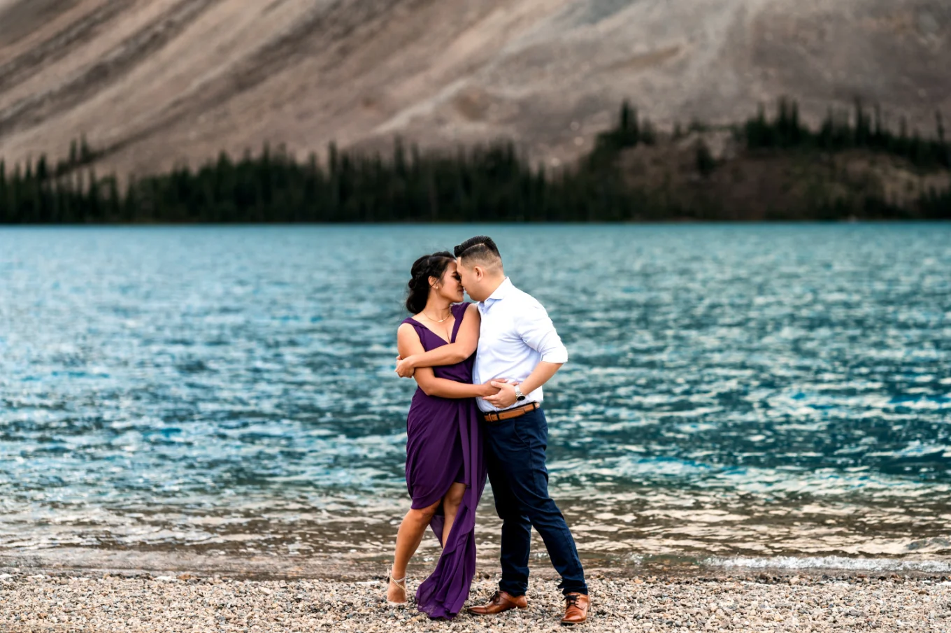 Engaged couple dance at Bow Lake and put their foreheads together.