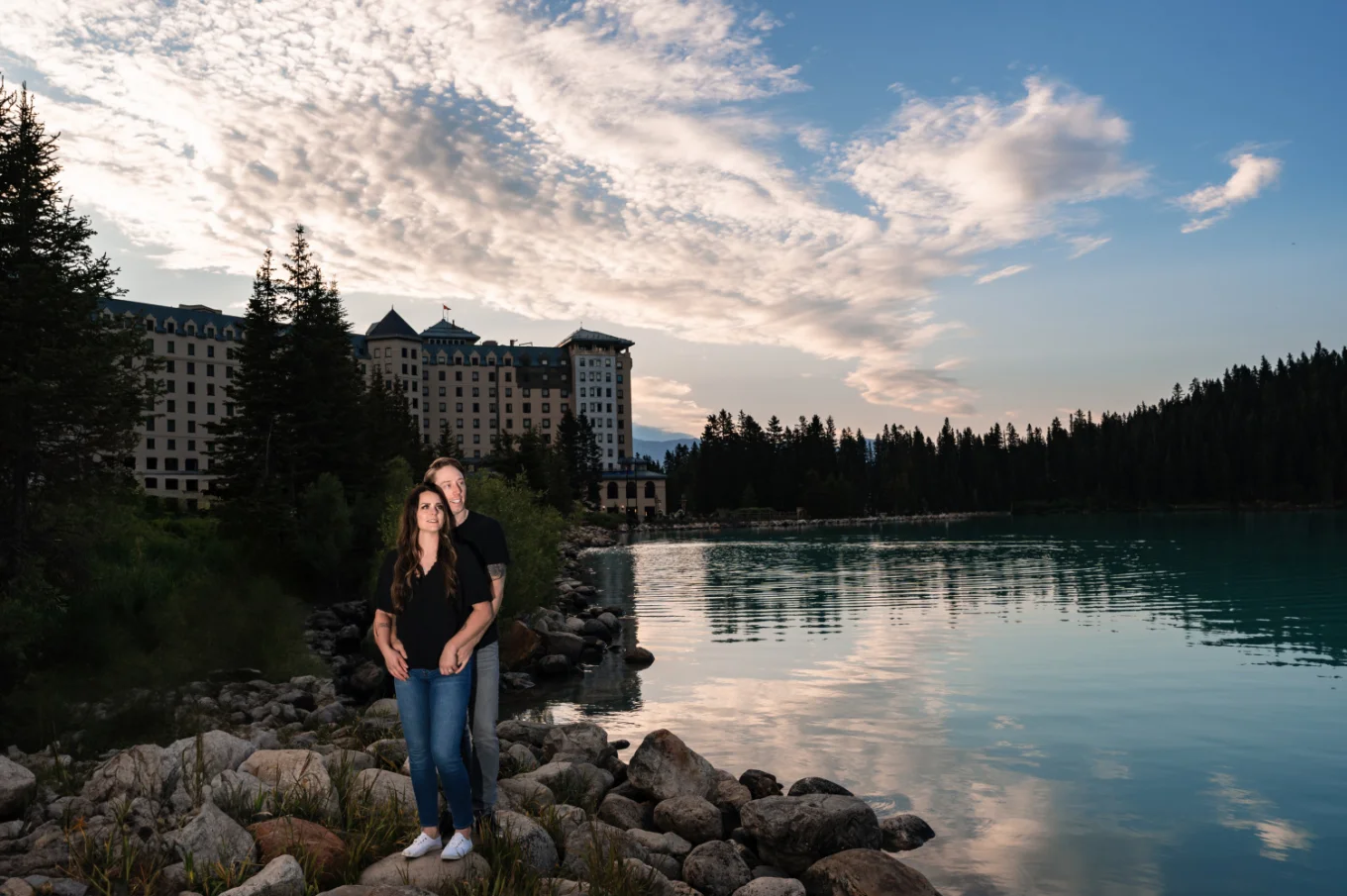 Engaged couple in front of Fairmont Hotel at Lake Louise