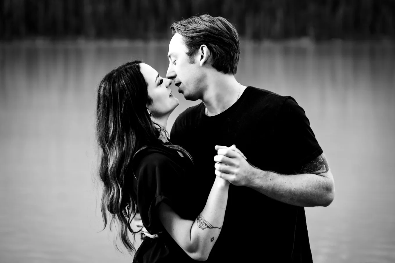 Couple in love hold their n hands and are about to kiss.