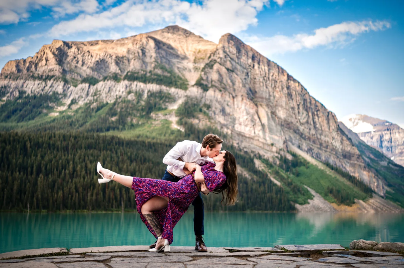 Lake Louise Engagement Photography of a dancing couple against a huge mountain
