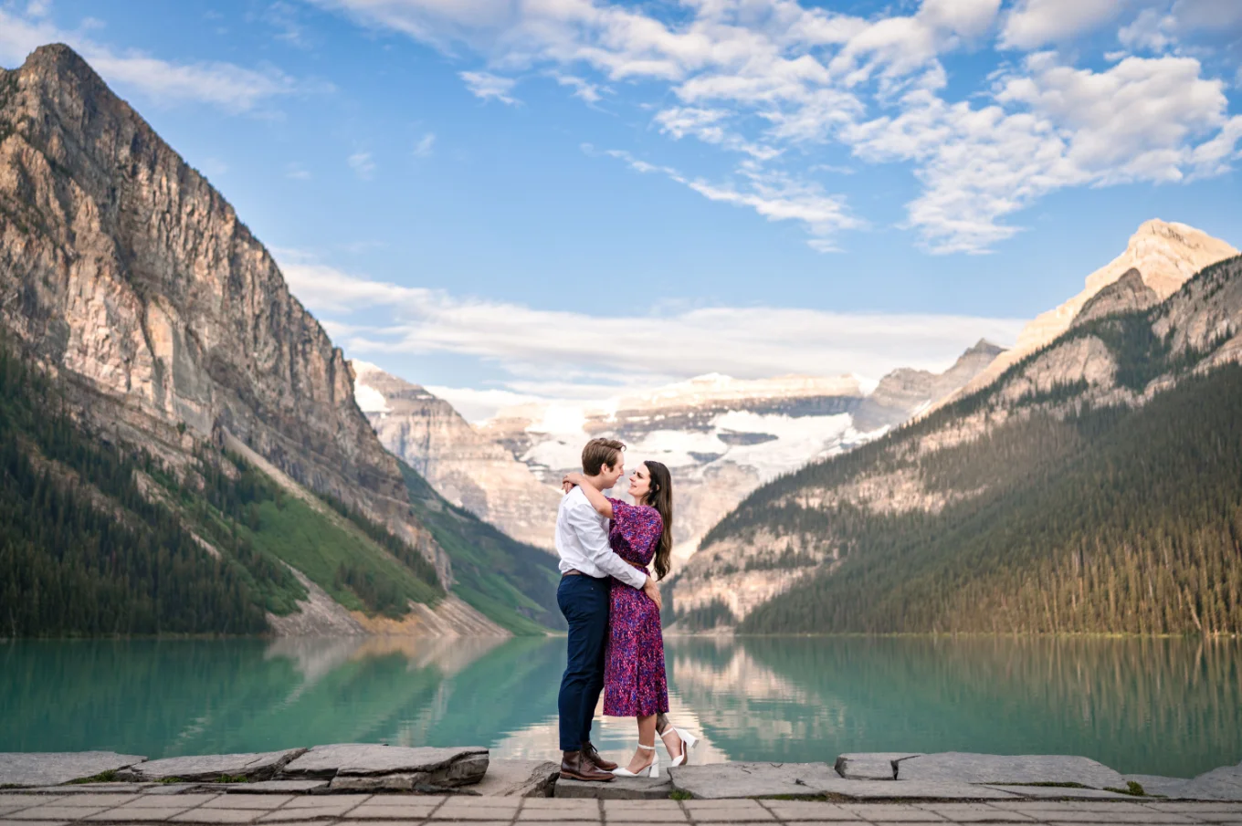 Romantic Banff Wedding Photography of the engaged couple at the shore of the Lake Louise.