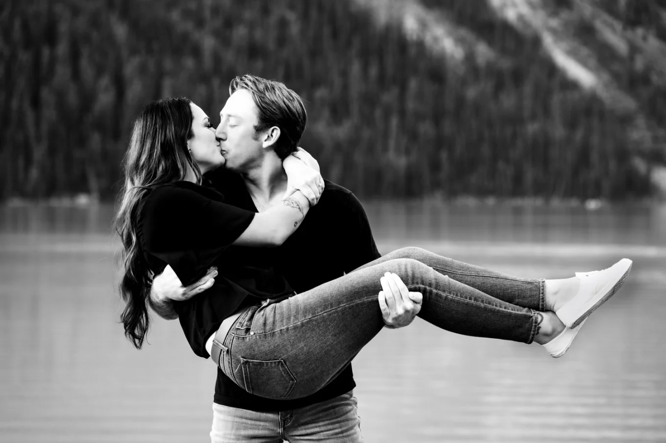 Man carry his fiancee and kiss her