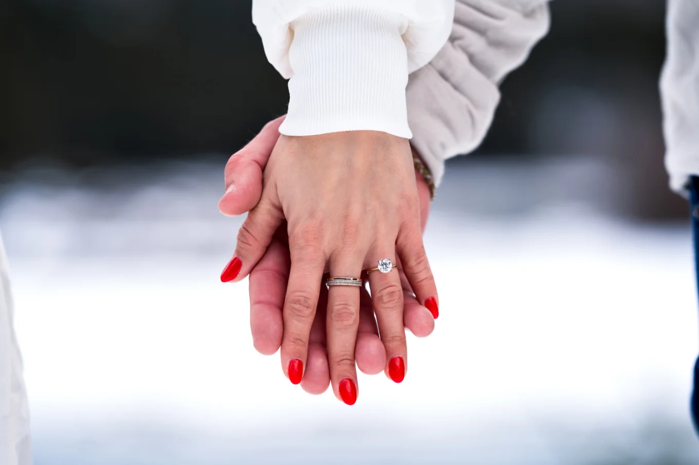 holding hands with an engagement ring