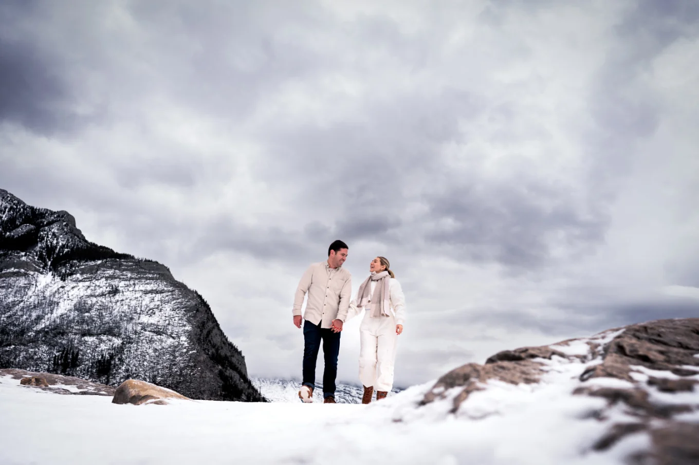 lovers walk during winter against the heavy clouds