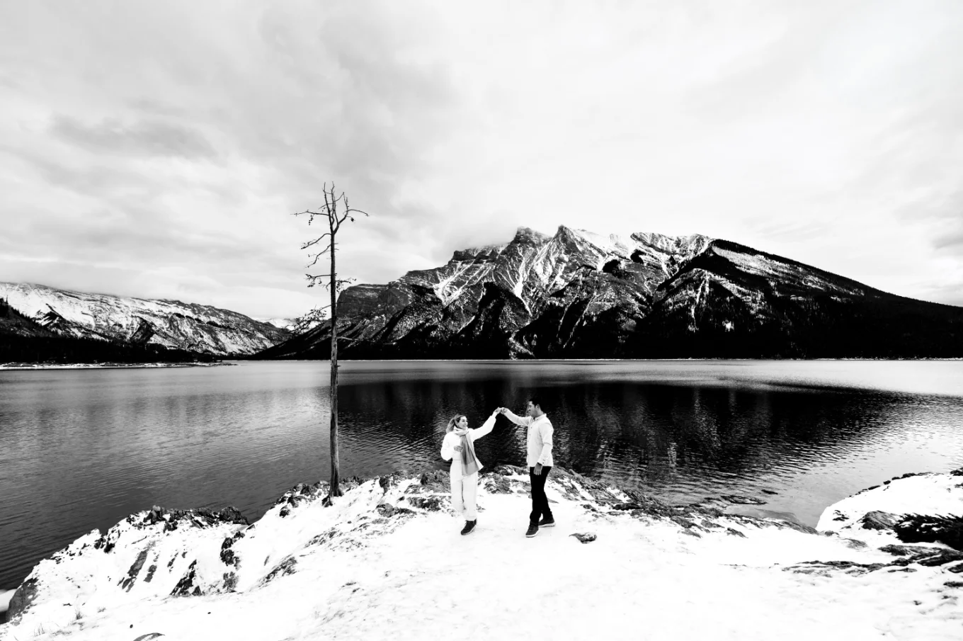 Banff's Winter Wonderland of engaged couple dancing by the Minnewanka Lake