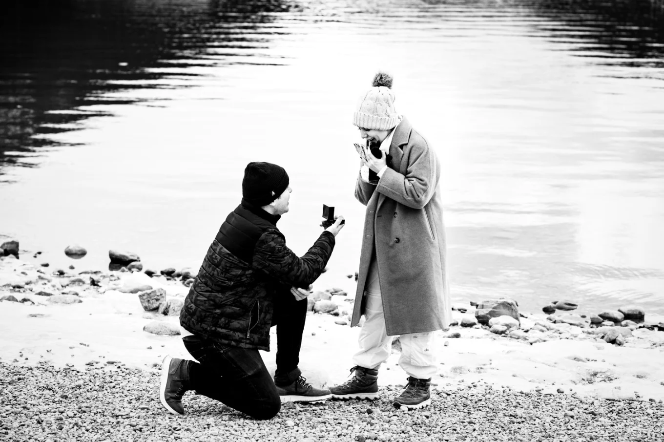 black and white photography of a mad sown the knee proposing with an engagement ring to fis girlfriend