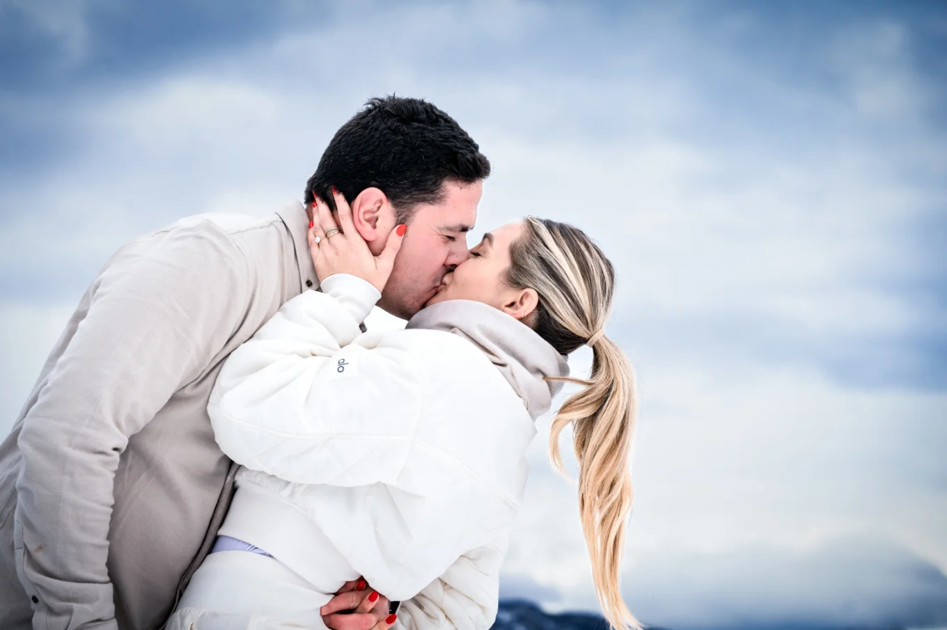 Engaged couple share a romantic kiss