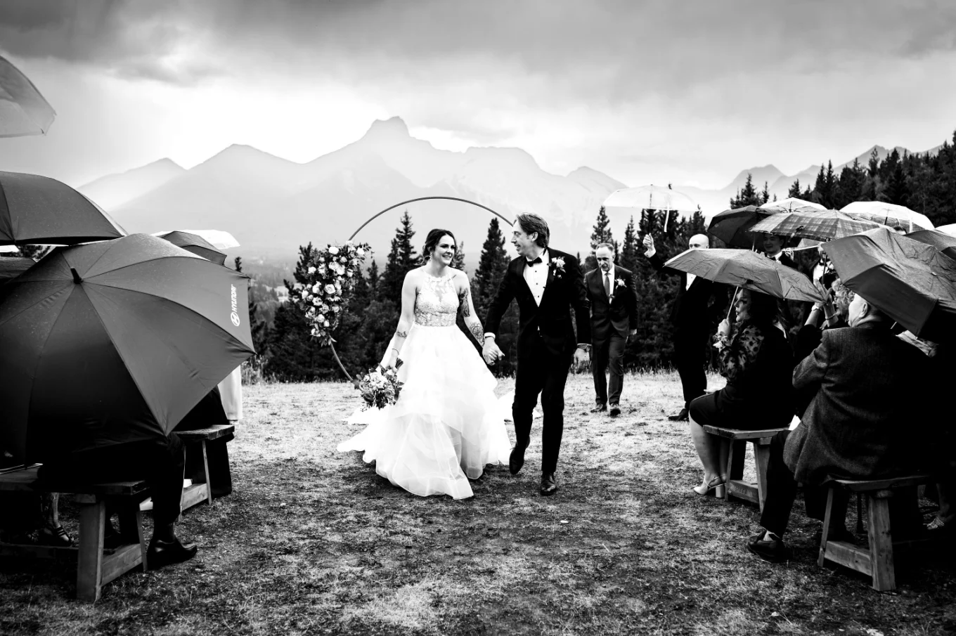 bride and groom walk down the aisle