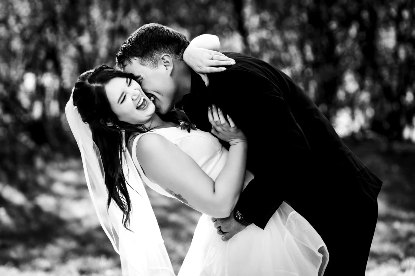 Groom kisses the bride during session in Calgary