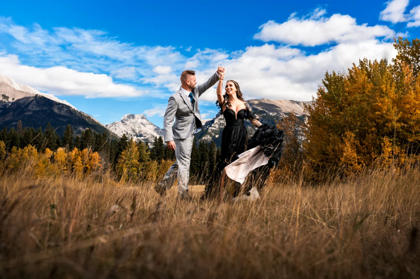 Groom's spinning the bride during portrait session in Canmore