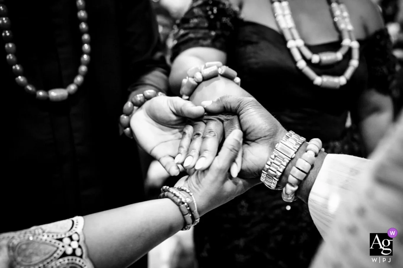 Hands of parents and newlyweds touching during Nigerian Wedding in Calgary.