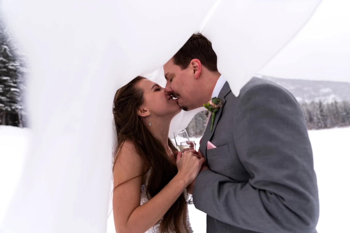 newlyweds kiss under the vail