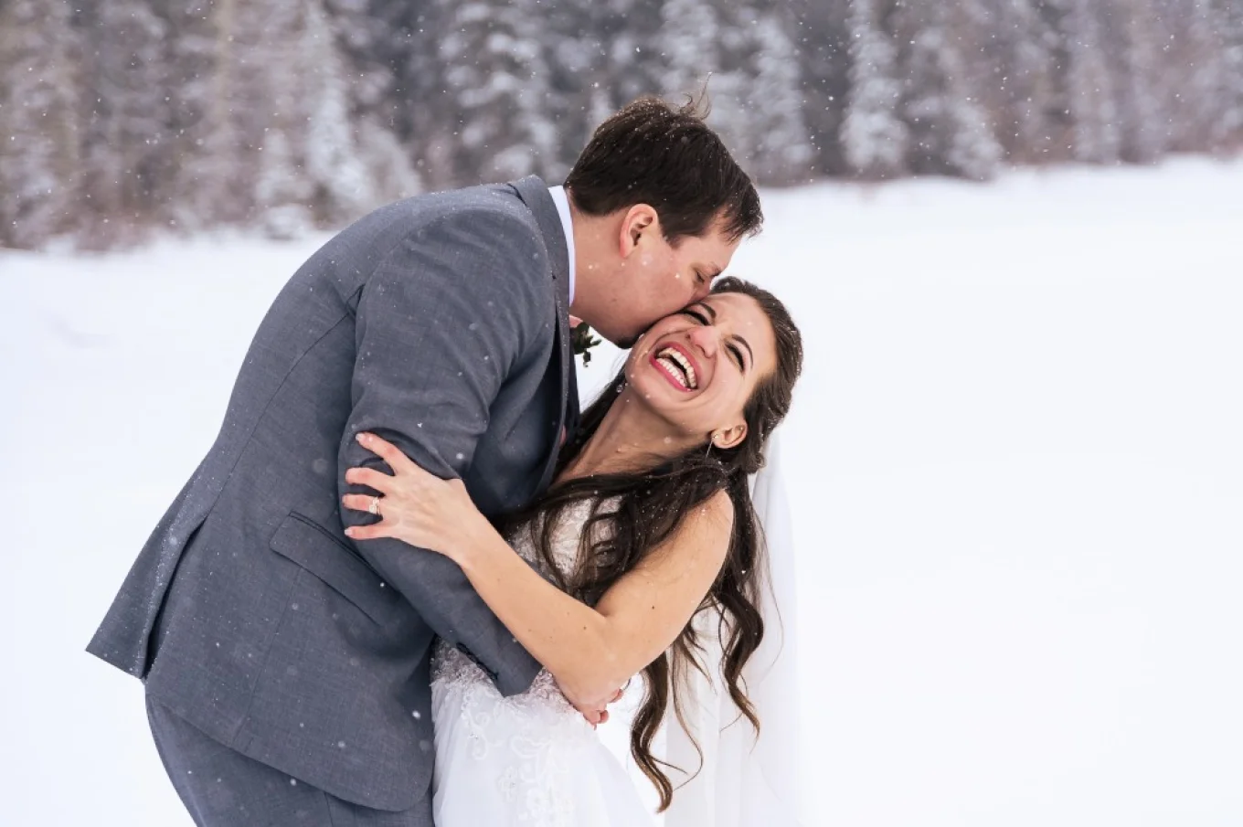 Groom kissing bride's cheek