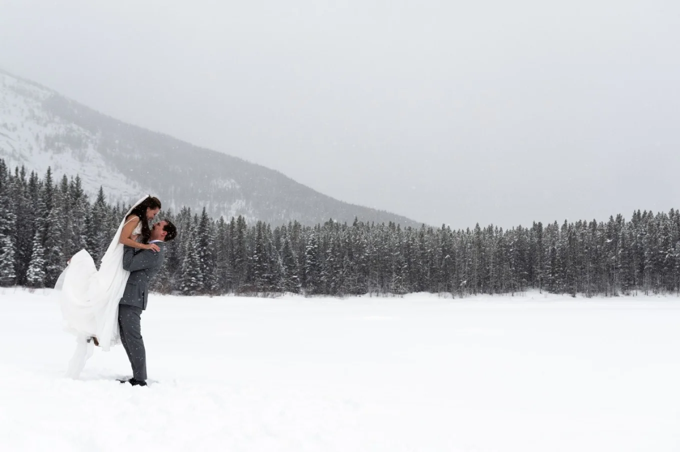 groom lifting the bride during mountain session with Banff Wedding Photographers