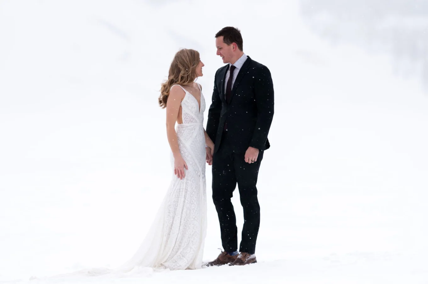 Newlyweds looking at each other during their after wedding photo session at Bow Lake