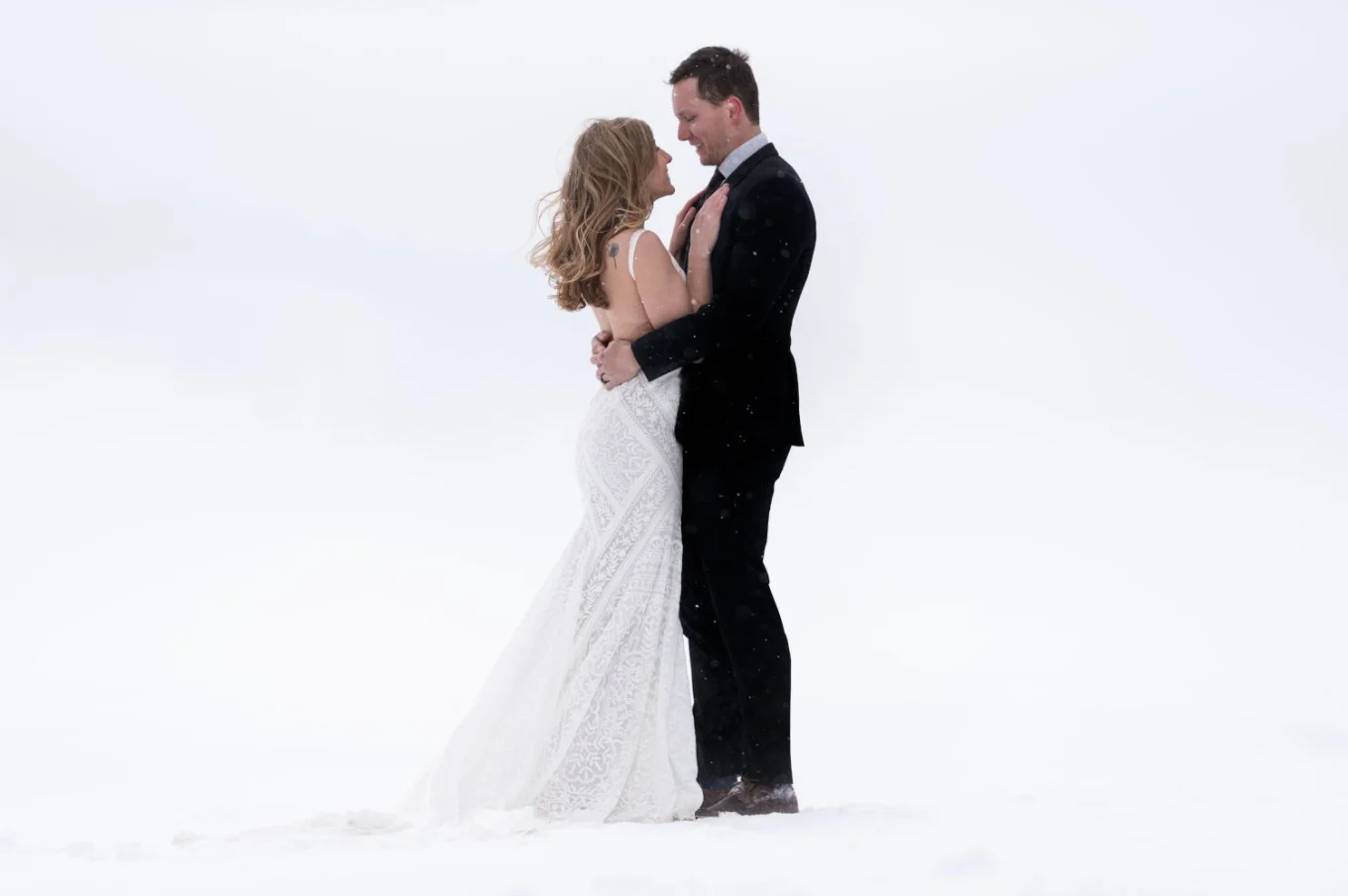 Winter after wedding photo shoot with hugging couple in love.