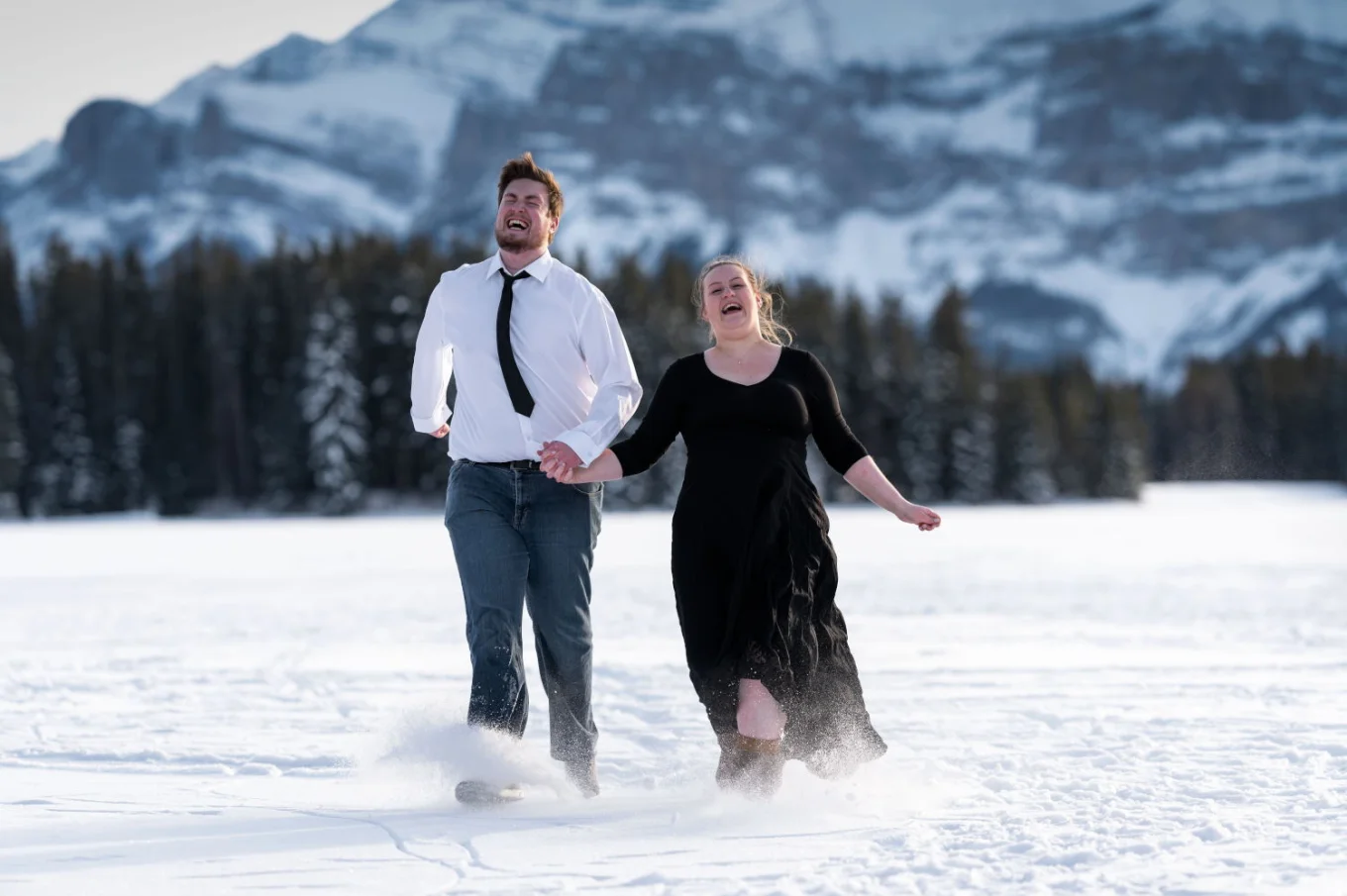 Engaged couple are having fun in the snow.