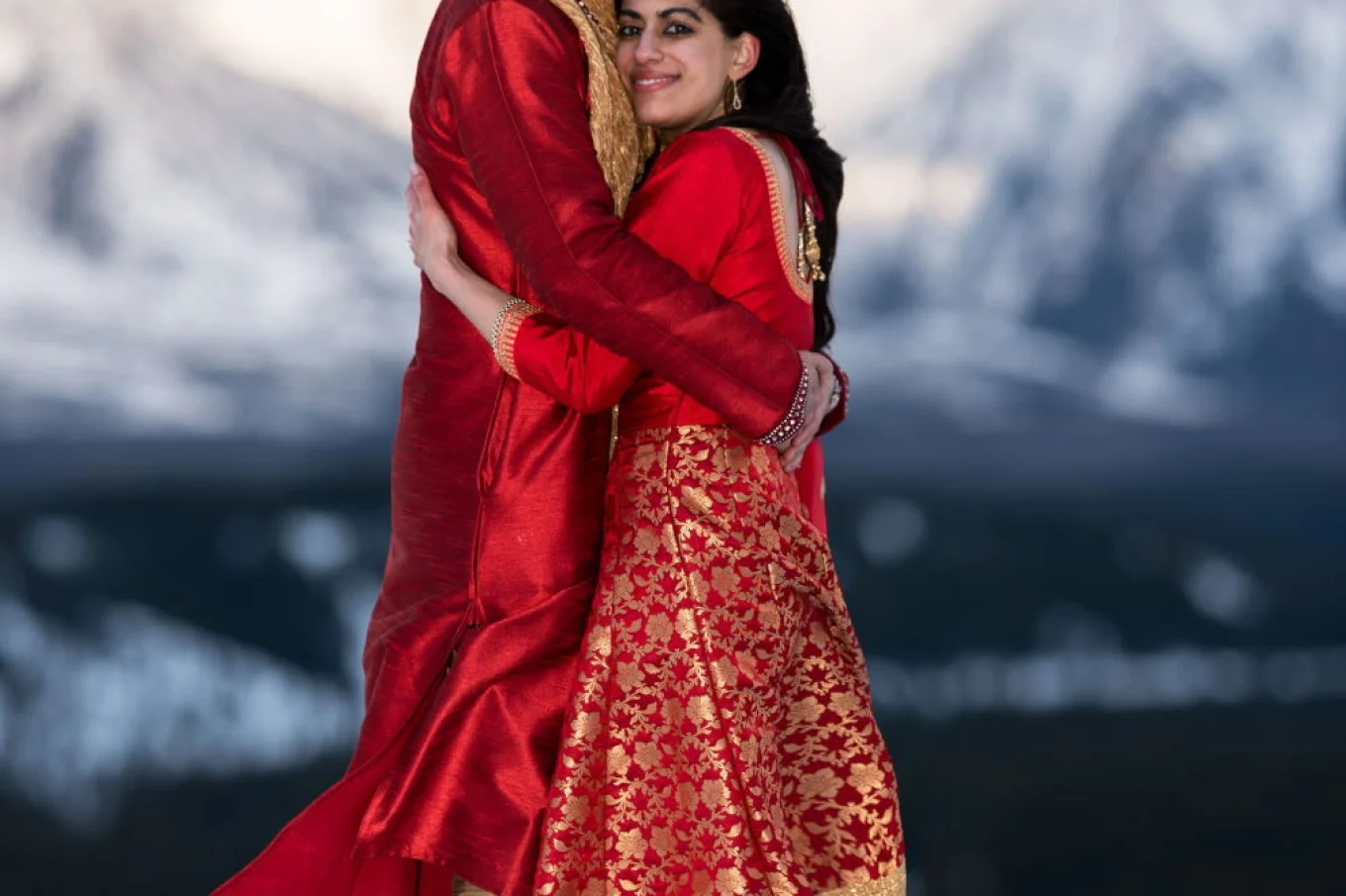 Newlyweds are hugging during their after wedding photo session in Banff.