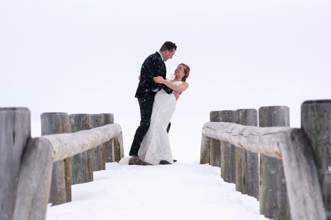 Bride and groom are dancing at the bridge in Banff