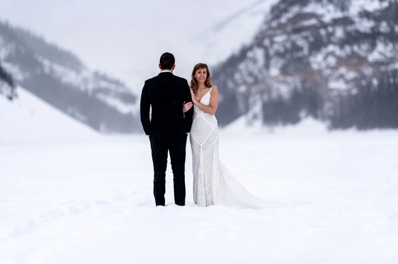 Lake Louise Wedding. Bride is smiling at the camera